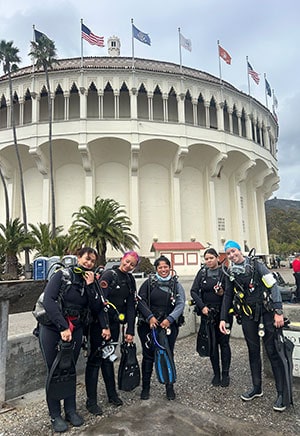 Divers preparing for a scuba dive at a historic site.