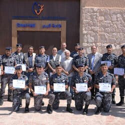 A group of uniformed officers holding Reef Check certificates