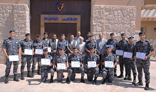 A group of uniformed officers holding Reef Check certificates