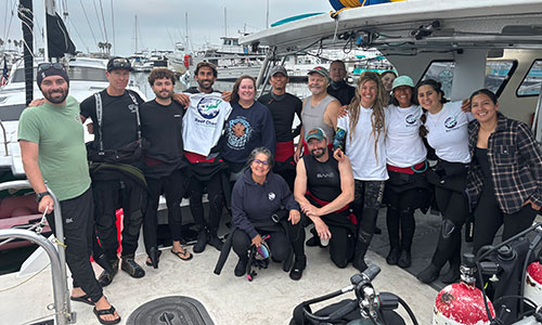 Volunteer Reef Check marine conservation team preparing for reef survey at marina.
